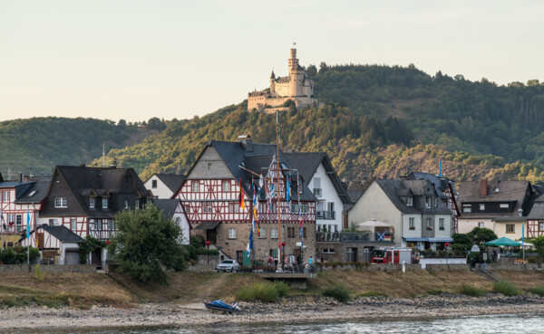 Marksburg  © Dominik Ketz Blick auf die Marksburg, umgeben von Wald, im Vordergrund der Rhein und Fachwerkhäuser © Dominik Ketz