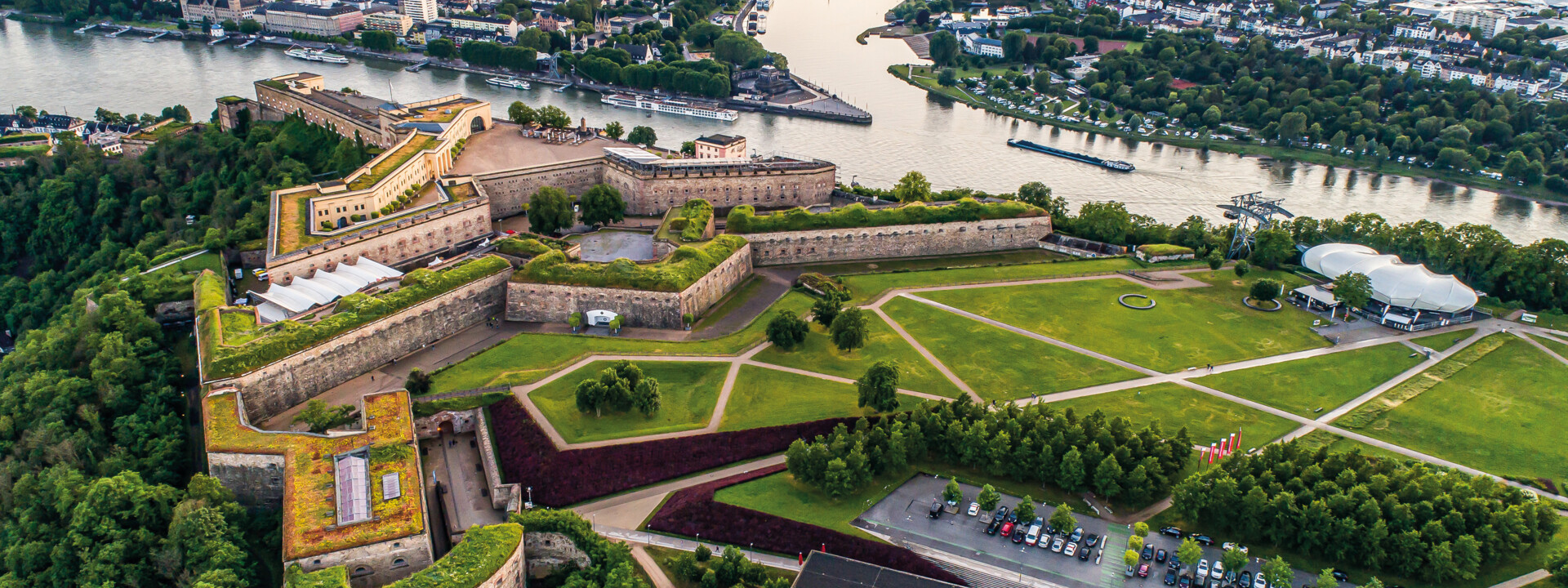 Aerial view of Festung Ehrenbreitstein with the Deutsches Eck, Rhine, Moselle and city of Koblenz in the background © Adobe Stock Aerial view of Festung Ehrenbreitstein with the Deutsches Eck, Rhine, Moselle and city of Koblenz in the background © Adobe Stock